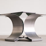 Modern metal table with a sleek design on a plain background