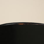 Close-up of a black surface with a beige background