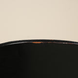 Close-up of a black surface with a beige background