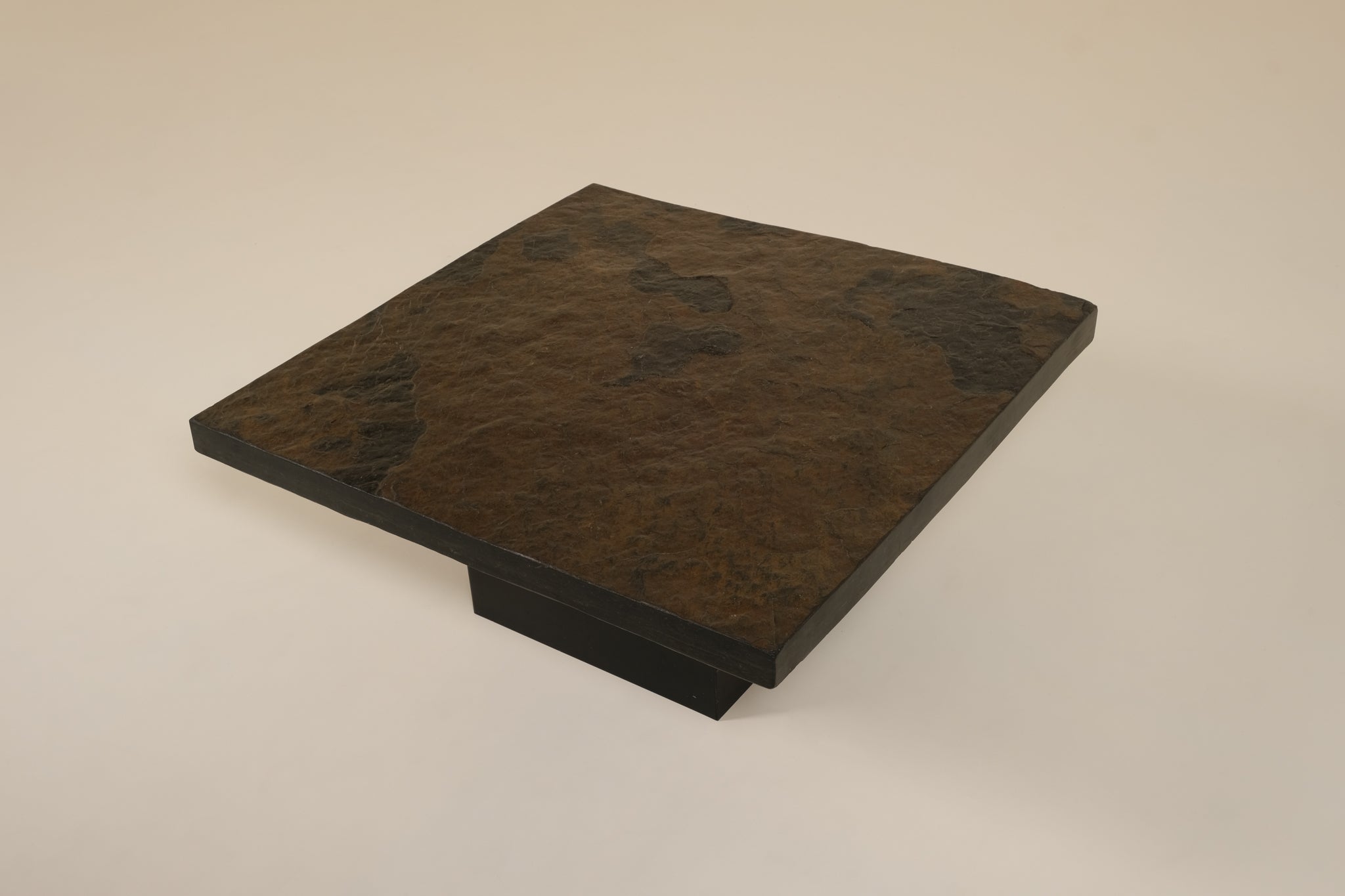 Dark brown stone slab on a beige background