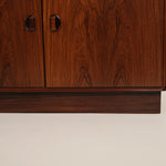 Close-up of a wooden cabinet with a smooth finish on a beige background
