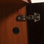 Close-up of a wooden cabinet with a visible brand logo on a dark background