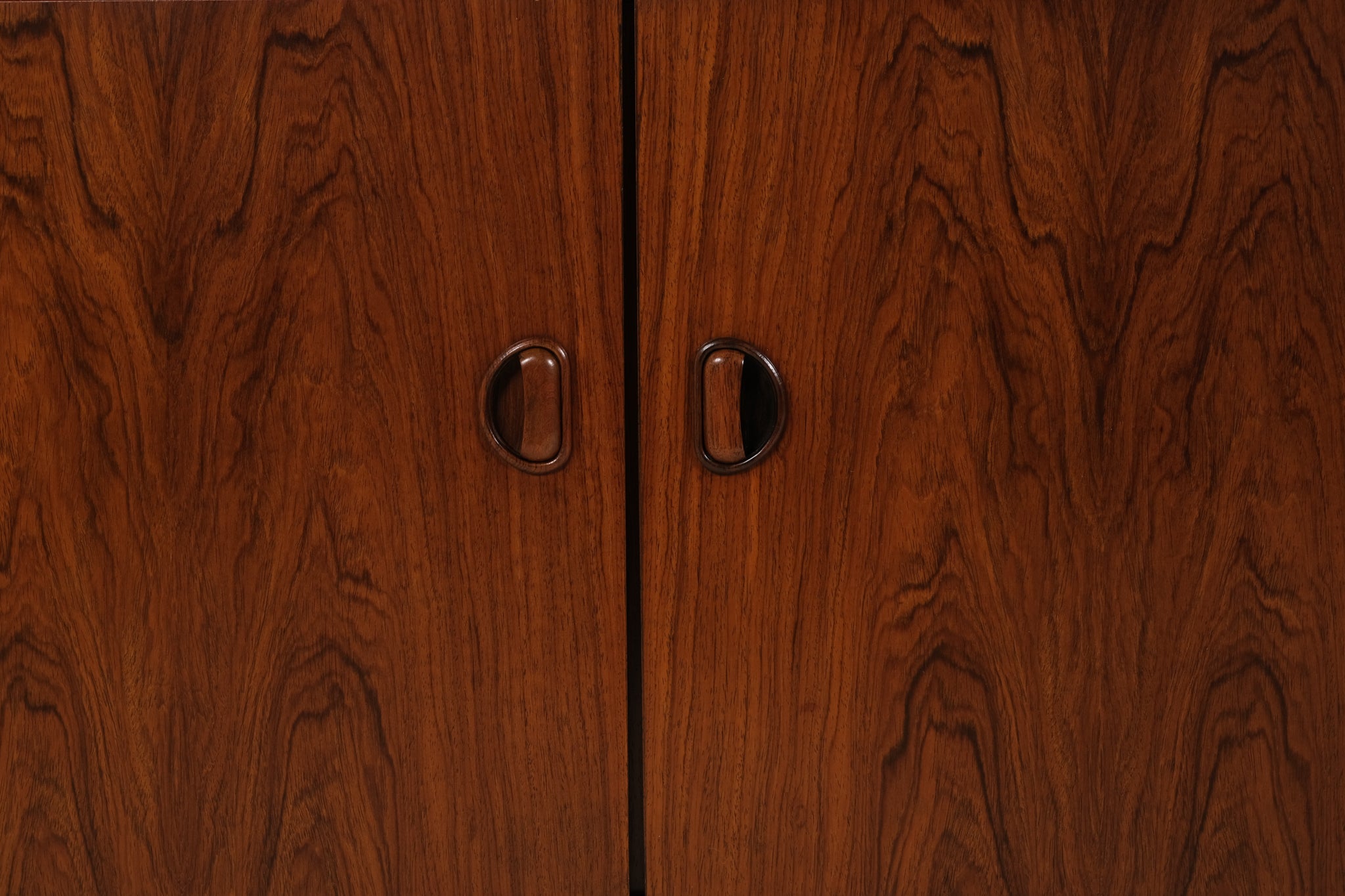 Close-up of a wooden cabinet with two handles