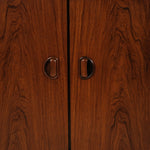Close-up of a wooden cabinet with two handles