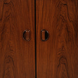 Close-up of a wooden cabinet with two handles