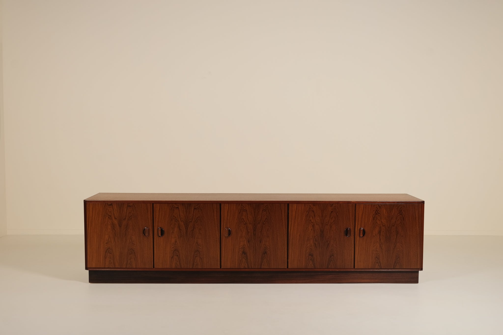 Wooden sideboard against a beige background