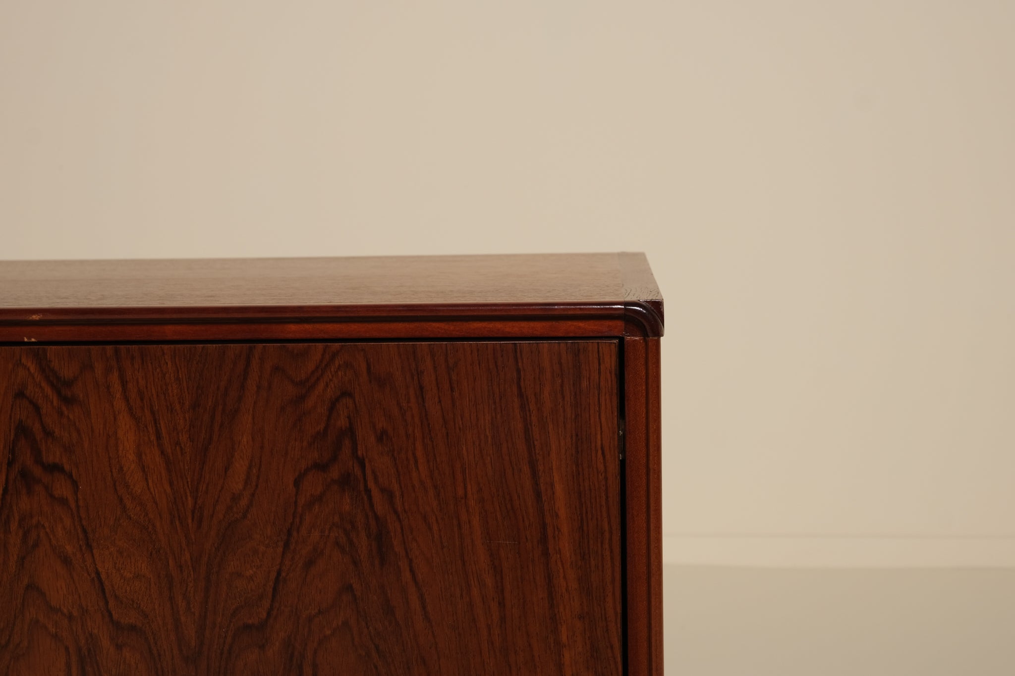 Wooden sideboard against a beige wall