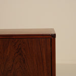 Wooden sideboard against a beige wall