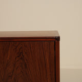 Wooden sideboard against a beige wall
