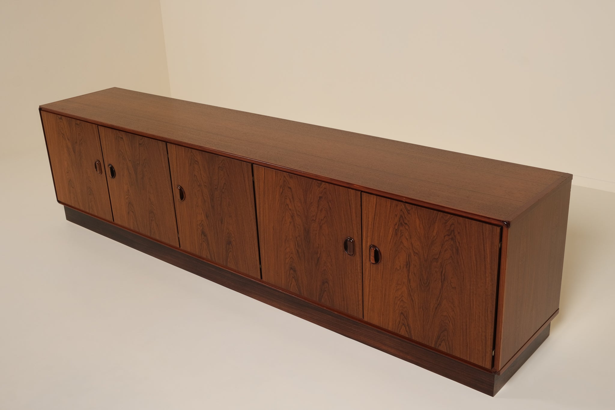 Wooden sideboard with four doors on a plain background