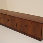 Wooden sideboard with four doors on a plain background