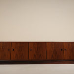 Wooden cabinet with four doors on a beige background