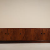 Wooden cabinet with four doors on a beige background