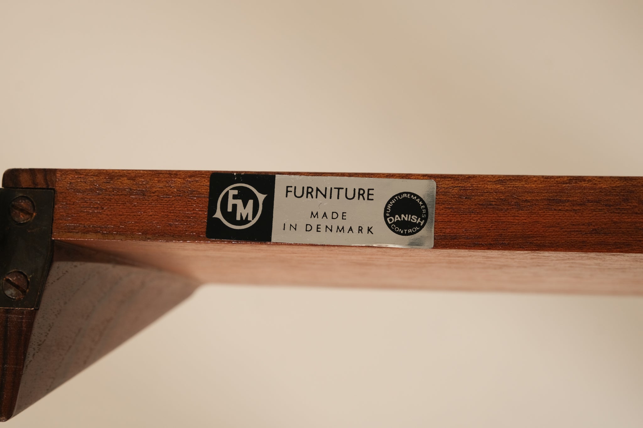 Wooden shelf with a label indicating 'Furniture Made in Denmark'.