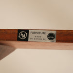 Wooden shelf with a label indicating 'Furniture Made in Denmark'.