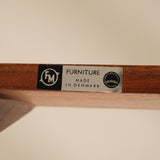 Wooden shelf with a label indicating 'Furniture Made in Denmark'.