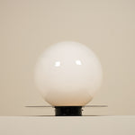 Glossy white sphere on a beige background
