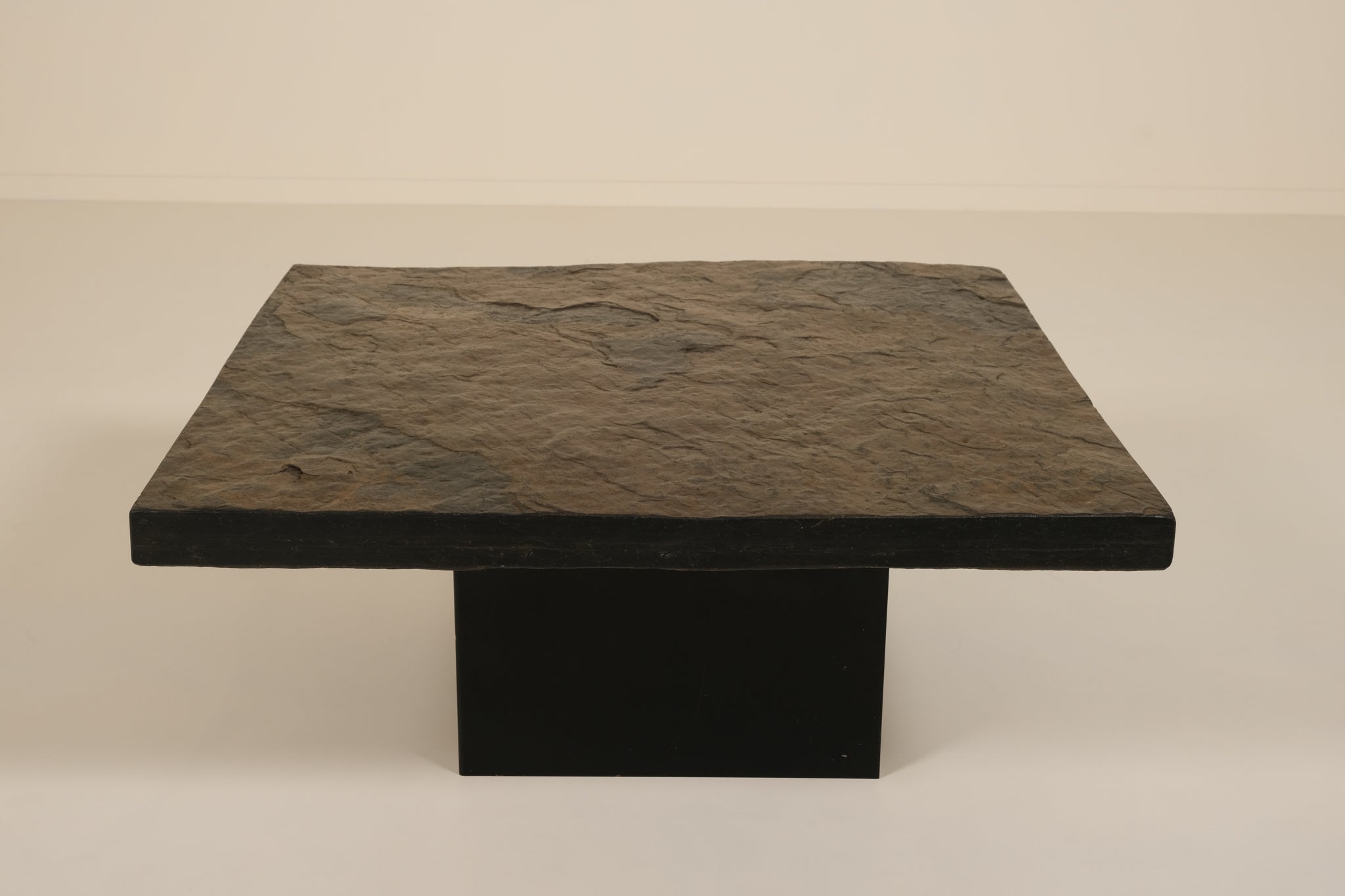 Dark stone coffee table on a beige background