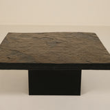 Dark stone coffee table on a beige background