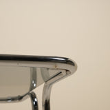 Close-up of a metallic table with a reflective surface on a beige background