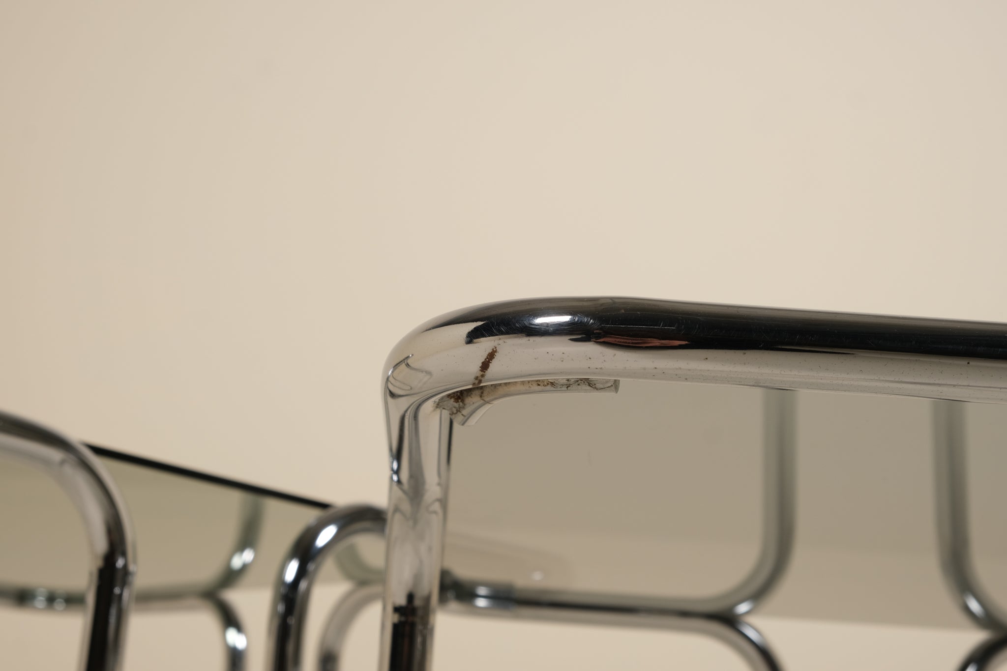 Close-up of a metallic table with a beige background