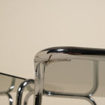 Close-up of a metallic table with a beige background