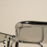 Close-up of a metallic table with a beige background