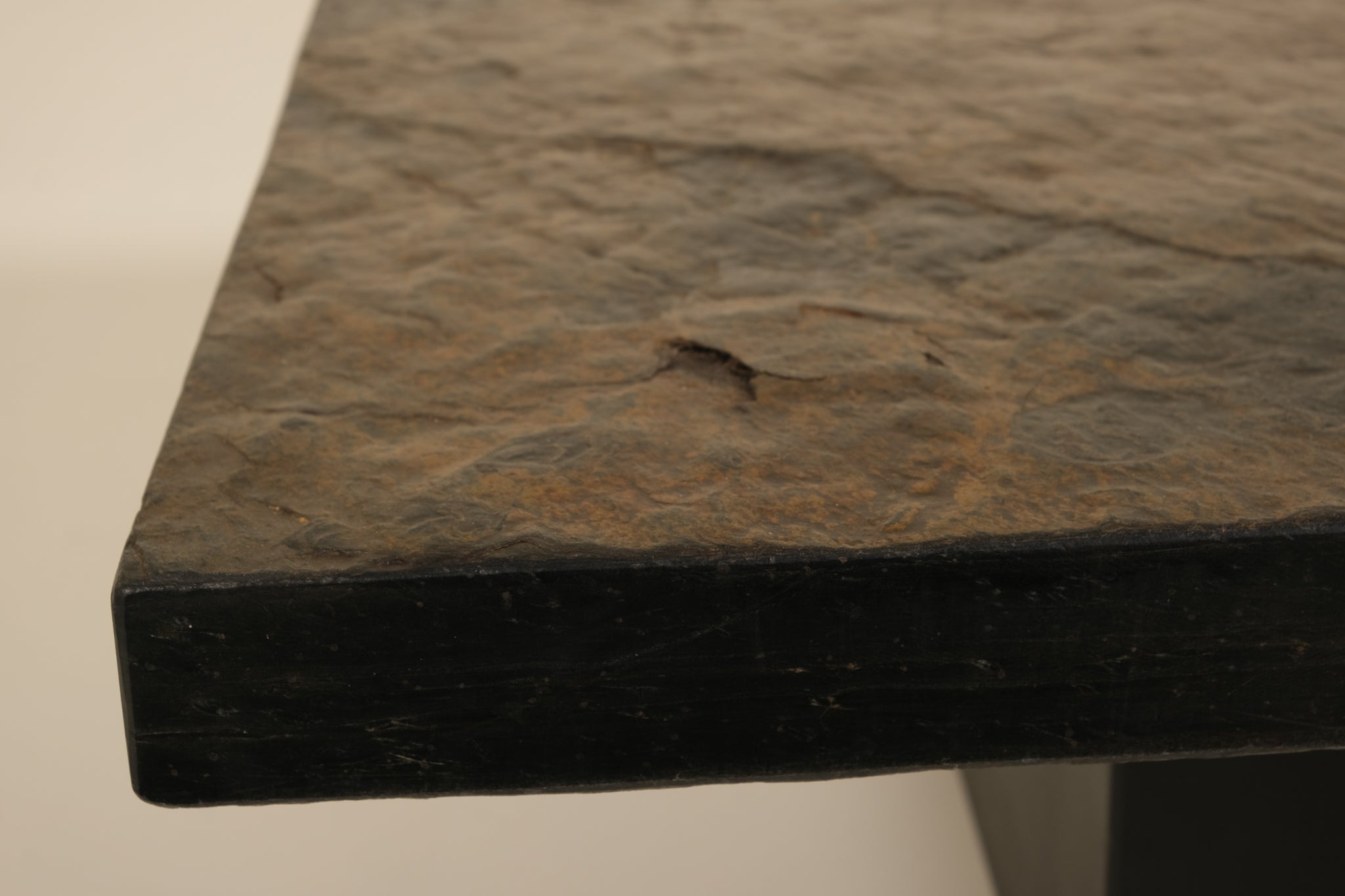 Close-up of a dark stone surface with a small crack