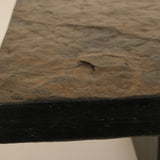 Close-up of a dark stone surface with a small crack