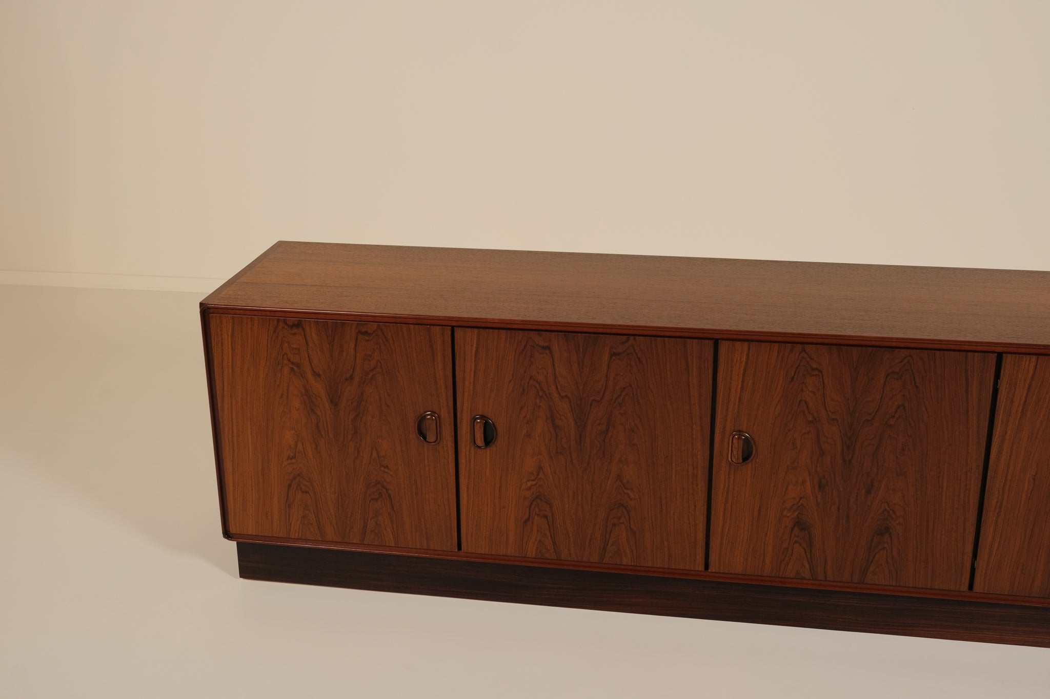 Wooden sideboard with four doors on a plain background