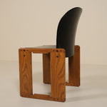 Wooden chair with a black seat and backrest on a beige background