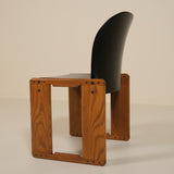 Wooden chair with a black seat and backrest on a beige background