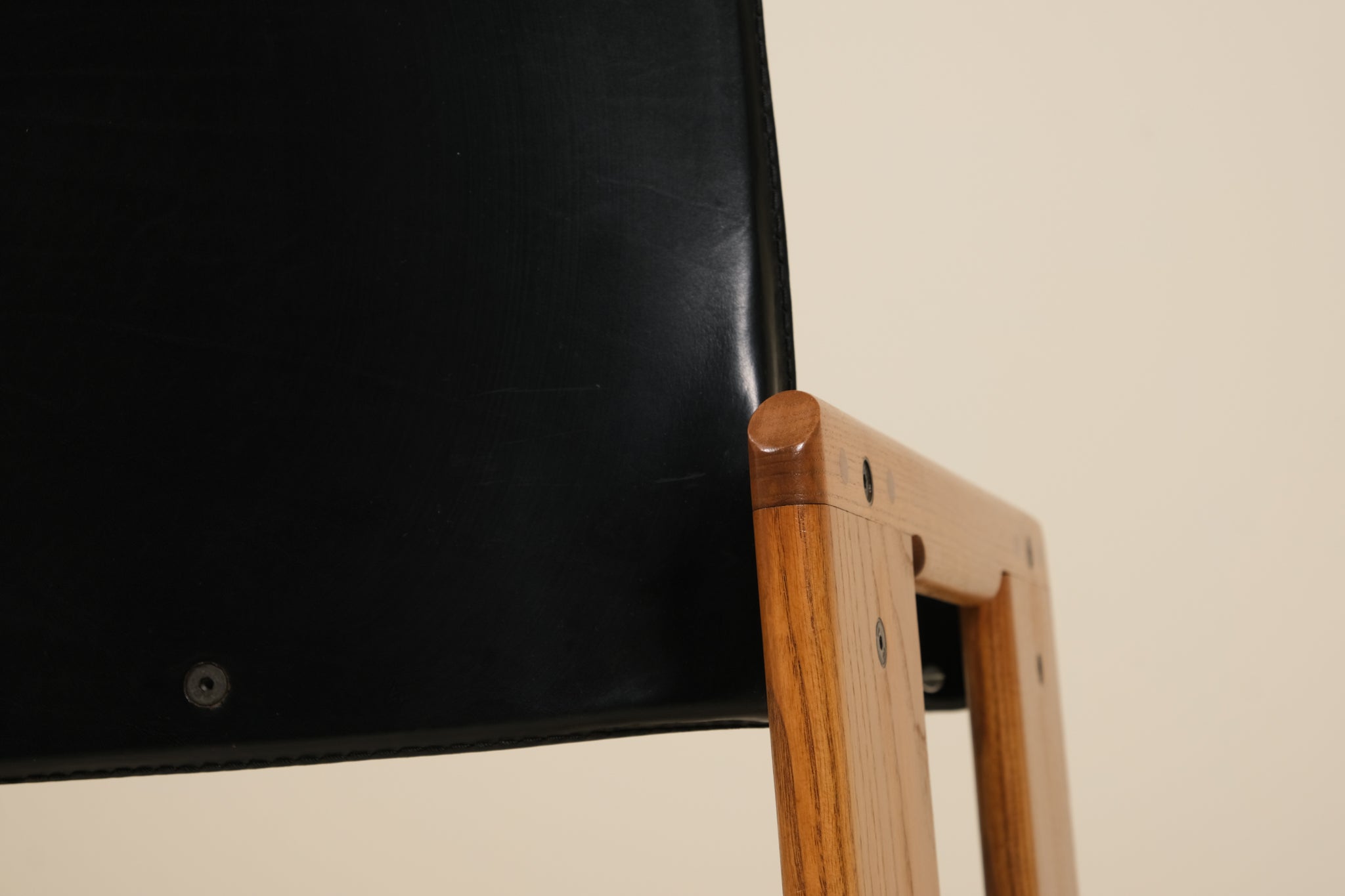 Black screen or panel with wooden frame on a beige background