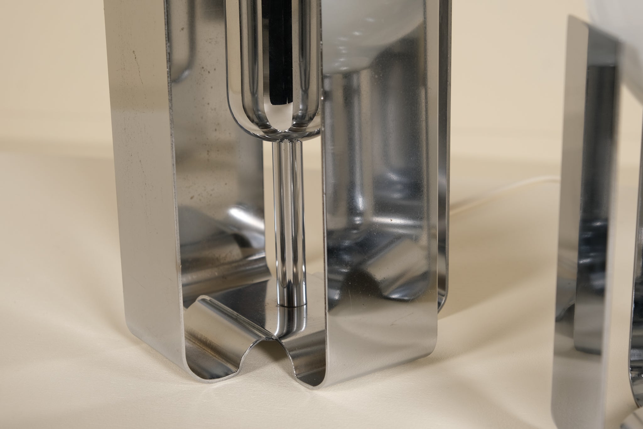 Metallic silver lamp on a beige background