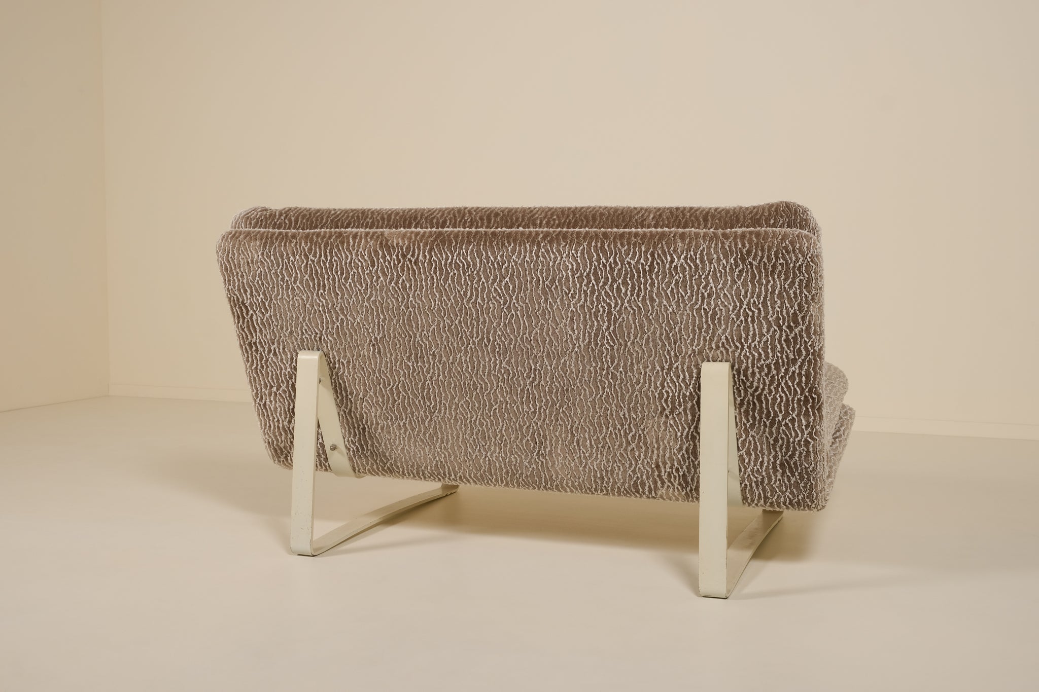 Back of an artifort sofa on a beige background