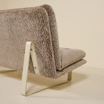 Back of a kho liang sofa with textured fabric on a beige background