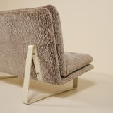 Back of a kho liang sofa with textured fabric on a beige background