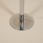 Chrome lamp base on a beige background