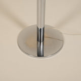 Chrome lamp base on a beige background