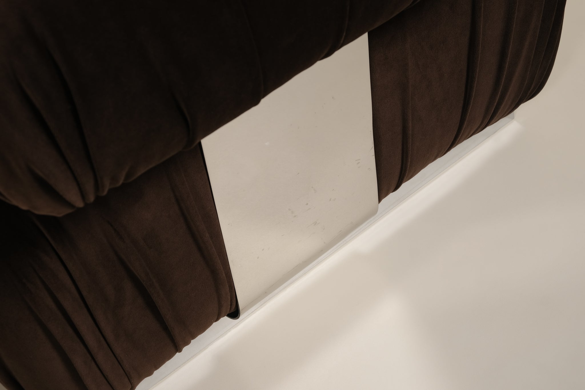 Close-up of a brown chair with a neutral background