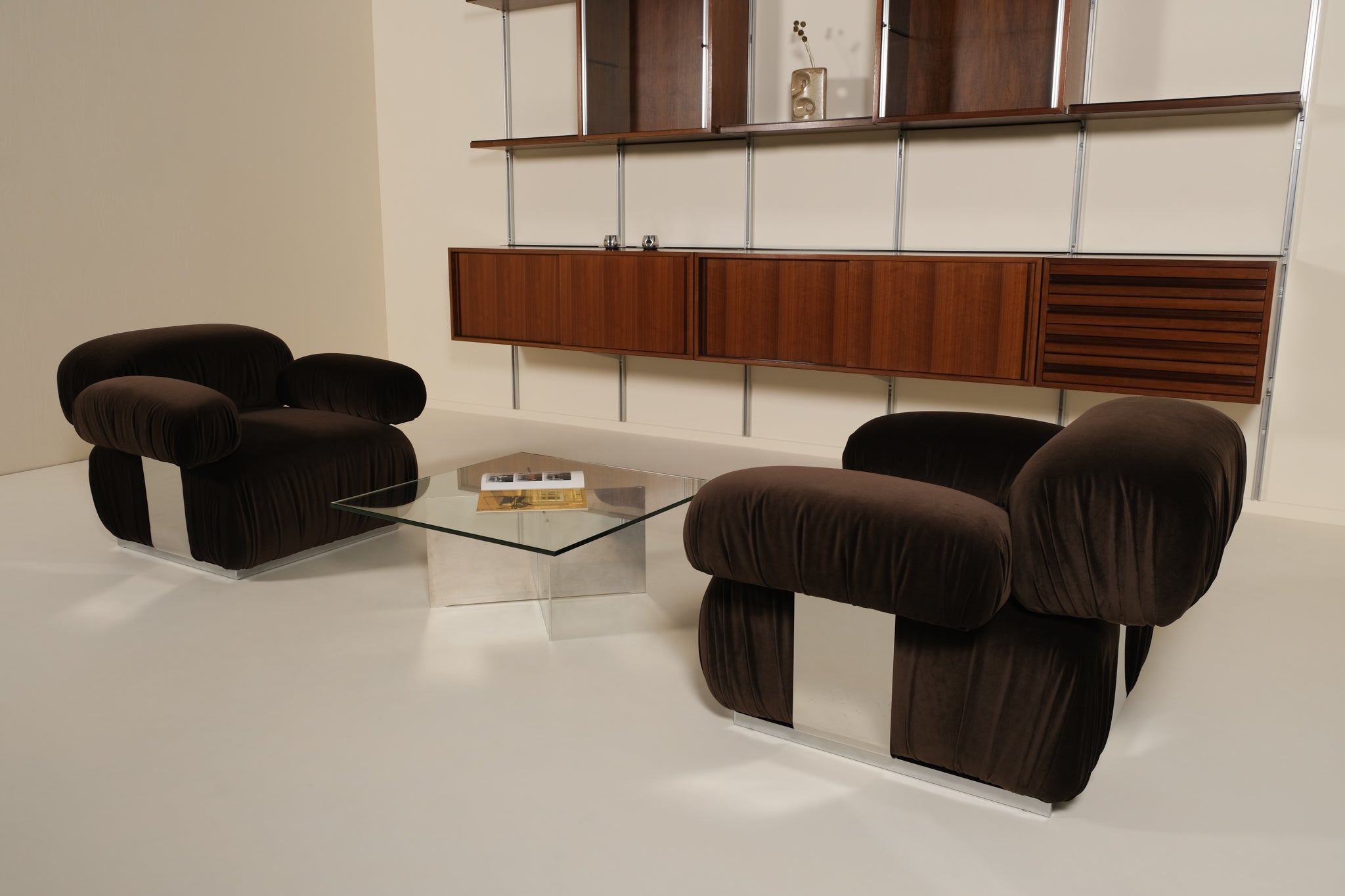 Modern living room with brown armchairs and a glass coffee table.