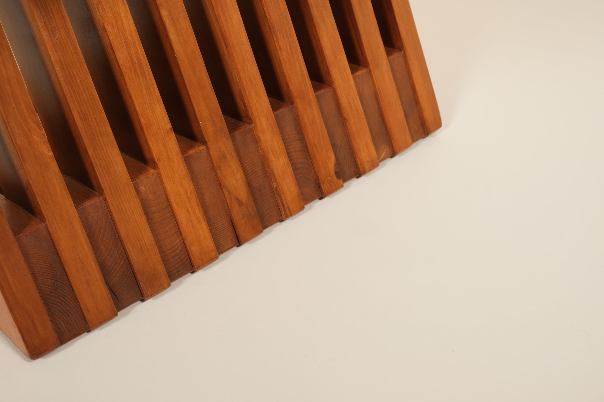Wooden slatted chair on a light beige background