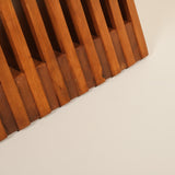 Wooden slatted chair on a light beige background