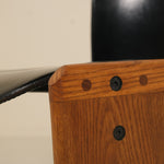 Close-up of a wooden chair with metal screws on a neutral background