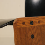 Close-up of a wooden chair with metal screws on a neutral background