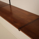 Wooden shelf with against a plain wall