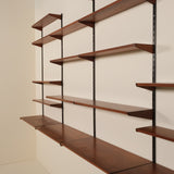Wooden shelves with metal brackets against a beige wall