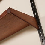 Wooden shelf bracket attached to a wall with a metal bracket.