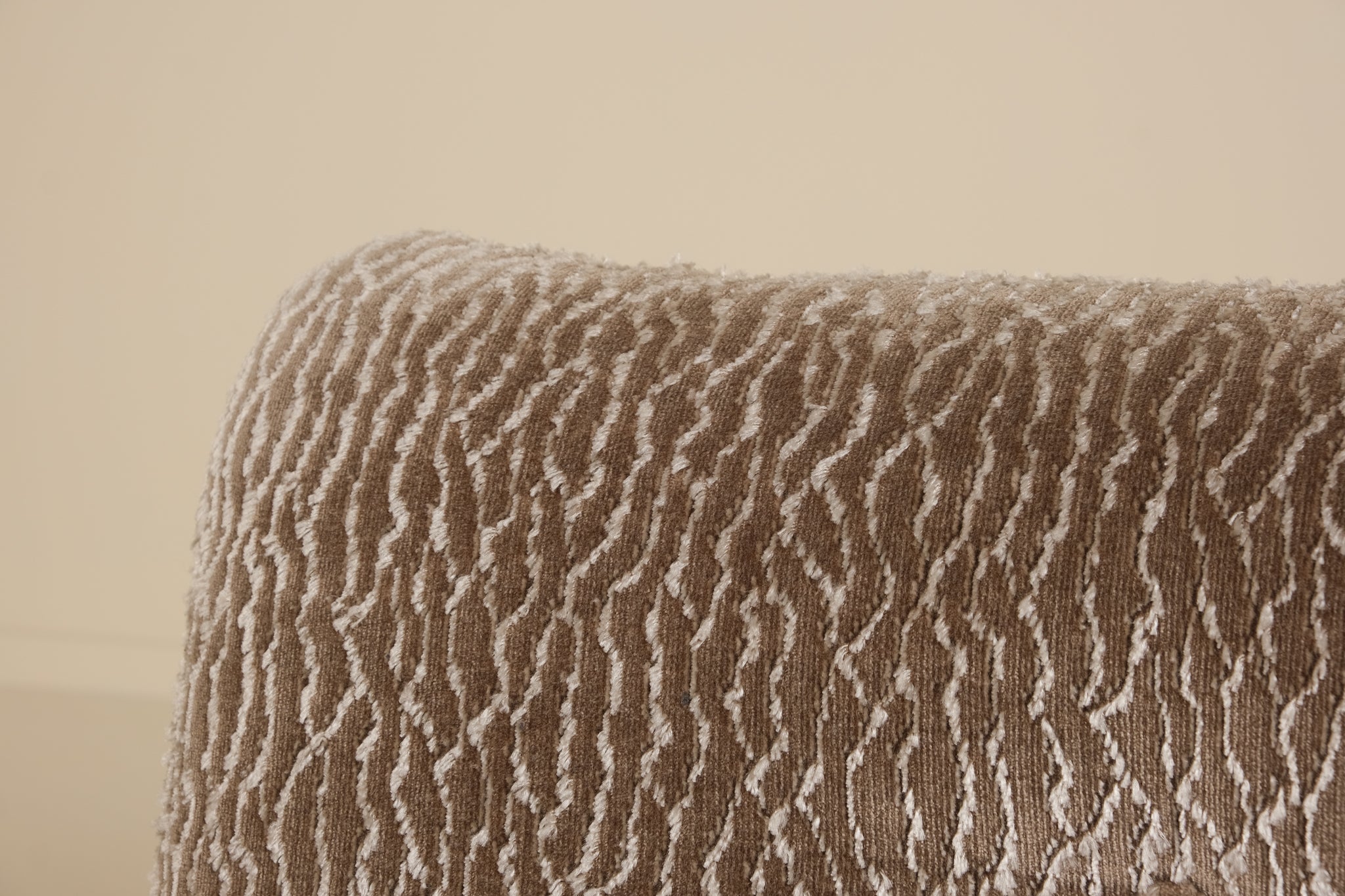 Textured brown fabric with wavy pattern on a beige background
