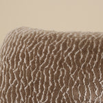 Textured brown fabric with wavy pattern on a beige background